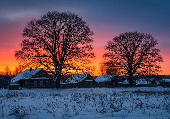 Зимний пейзаж с русской деревней на закате